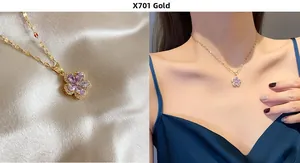 Detail view of flower pendant necklace with purple gemstone and gold water wave chain