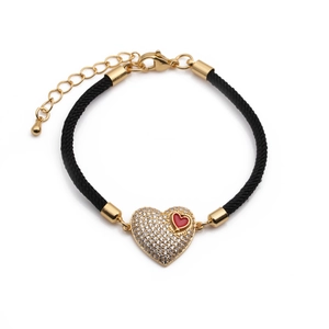 Close-up of heart charm woven bracelet with red enamel inlay and cubic zirconia stones