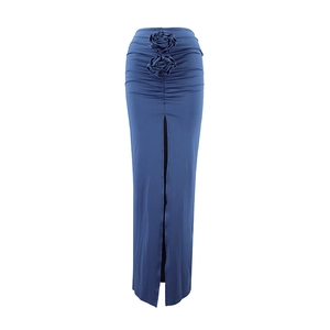 Detail of high waist dark blue skirt featuring 3D floral accents and elegant front slit