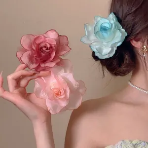 Three large mesh fabric rose hair clips in pink and blue for elegant styling and vacations