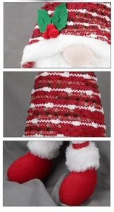 Detail of red Christmas gnome tree topper with knit fabric and faux fur textures