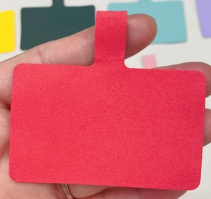 Close-up of a red felt phone tether tab with ring for universal crossbody lanyard