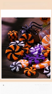 Macro shot of Halloween resin swirl candy charms with orange, purple, and black spiral details