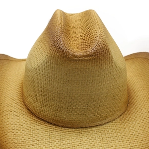 Close-up of woven straw cowboy hat crown showing detailed texture and retro brown color
