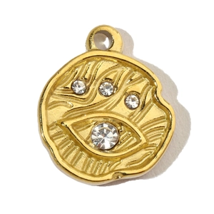 Macro shot of gold evil eye pendant with sparkling crystals and radial texture
