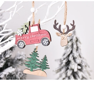 Detail of wooden Christmas ornaments featuring red truck and deer on a festive branch