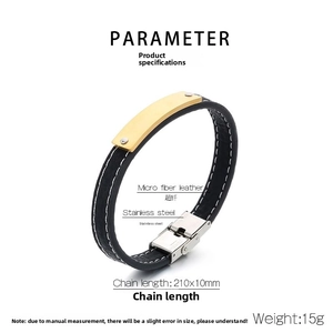 Detail of black microfiber leather bracelet with gold stainless steel identity plate
