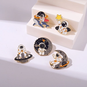 Set of 5 astronaut enamel pins featuring space moon and whale designs on metal