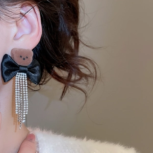 Detail of bear stud earring with black bow and dangling silver rhinestone tassels