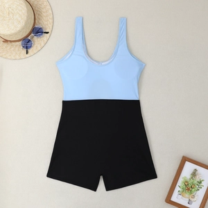 Detail of color-block one-piece swimsuit with blue racerback top and black boyshorts