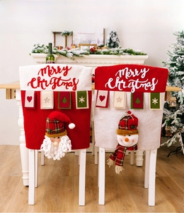 Detail of Santa and Snowman chair covers with Merry Christmas text and 3D plush details