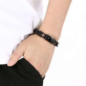 Close-up of black 12mm Cuban chain bracelet with rectangular ID tag on male wrist