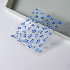 Macro detail of Klein blue 5D embossed nail stickers featuring floral and vine patterns