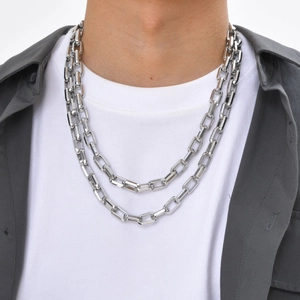 Men's silver rectangular link chain necklace in stainless steel worn by a model