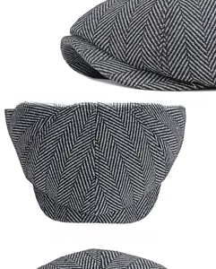 Detail of grey herringbone newsboy cap featuring a reinforced brim and wool texture