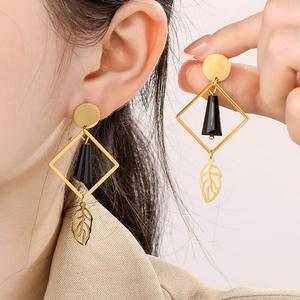 Golden titanium steel earrings with black geometric pendant and delicate leaf charm