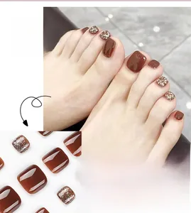 Detail of caramel brown and champagne glitter press on toe nails for a stylish pedicure