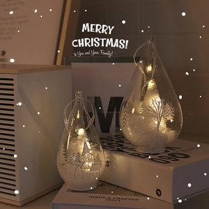 Set of two glowing glass teardrop Christmas trees with snowy village scene and LED lights