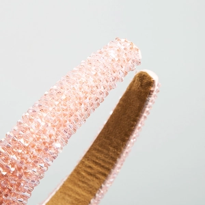 Detailed close-up of light pink crystal beaded padded headband with velvet lining