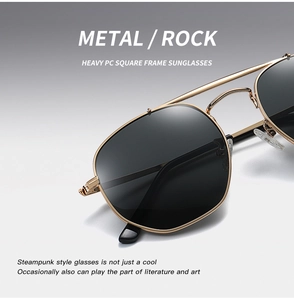 Detail of warm gold metal frame sunglasses with dark black lenses in punk rock style