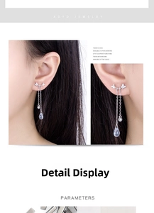 Detailed close-up of S999 silver butterfly tassel earrings with moonstone teardrop accents
