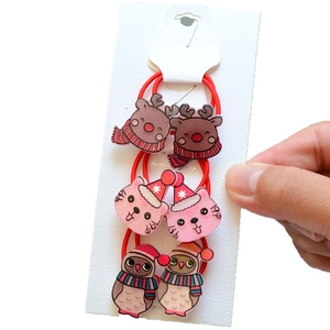 Detail of 6pcs Christmas hair ties featuring reindeer and cat charms on white card