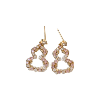 Elegant gold hollow wulu stud earrings with pink and white pavé cubic zirconia crystals