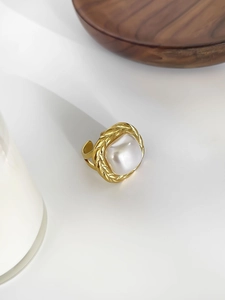 Detail of 18k gold plated braided ring featuring a square pearl inlay and open band