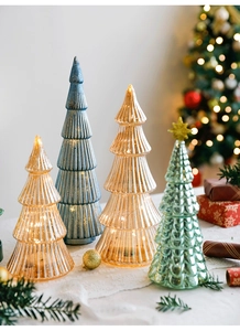 Detail of illuminated glass Christmas trees with ribbed textures and glowing LED lights