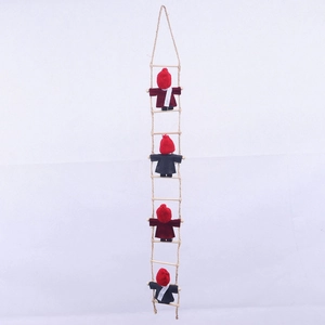 Detail of wool felt gnomes climbing a wooden rope ladder for Christmas fireplace decor