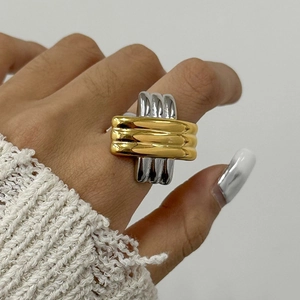 Two-tone mixed metal criss-cross ring with wide band design and polished gold silver finish