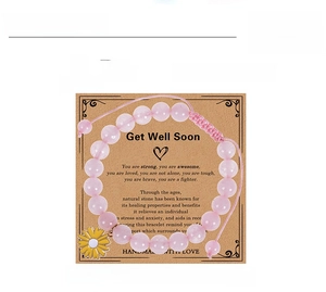Detail view of 8mm pink crystal bead bracelet with sunflower charm on a gift card display