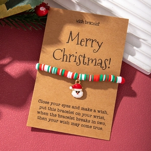 Christmas wish bracelet with red and green clay beads and Santa Claus charm on a gift card