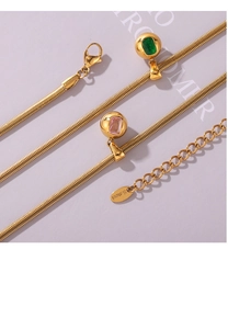 Macro shot of 18k gold plated stainless steel necklace with pink and green zircon pendant