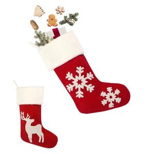 Red and white knitted Christmas stockings with reindeer and snowflake embroidery for decor