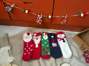 Detailed view of warm coral fleece Christmas socks featuring festive holiday patterns