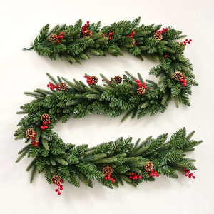 Lush snow-tipped Christmas garland with red berries and pine cones on a white background