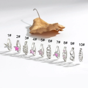 Set mit 10 silbernen Bauchnabelpiercings mit rosa Edelsteinen und Sternen auf Weiß