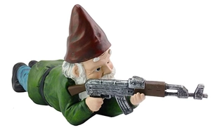 Detail of hand-painted resin garden gnome holding a rifle in a tactical prone position