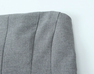 Vue macro du bustier gris montrant la texture fine du tissu et les détails de couture