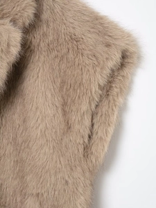 Macro view showing the soft texture of light brown faux fur on this short vest garment