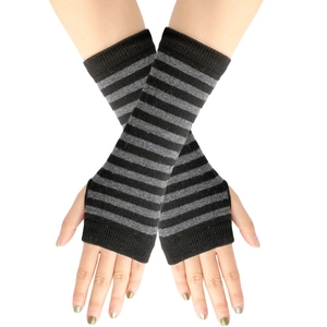 Detail of black and grey striped knitted fingerless gloves worn on hands over white background