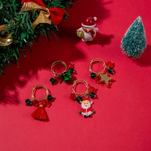 Detail view of 4-piece Christmas earring set with Santa, bell, and star pendants
