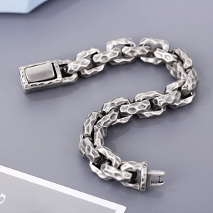 Detail of vintage hip hop stainless steel bracelet with hammered pattern links