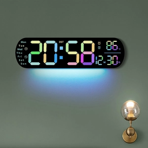 Multifunctional LED digital wall clock with large color display on a grey wall