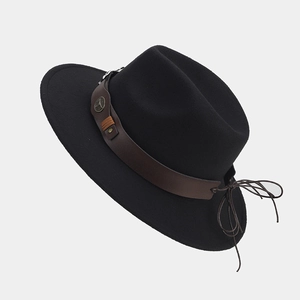 Primer plano de sombrero de fieltro negro con banda de cuero marrón y hebilla metálica