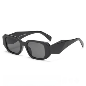 Detail of geometric cut temples and CE mark on black rimless designer sunglasses