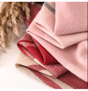 Close-up of soft pink and red plaid cashmere-like scarves with rich woven texture