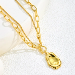Double-layered gold stainless steel necklace featuring a chunky link chain and OT toggle