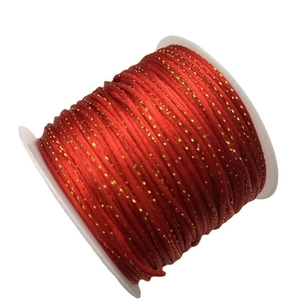 Red and gold braided cord on a white spool for DIY jewelry and knot making